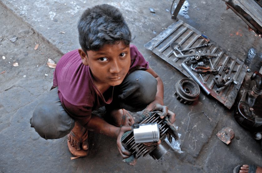 Young child holding car parts