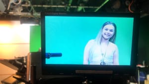 Hannah at the ITV studios on a monitor infant of green screen