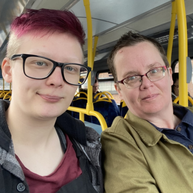 Two people sat in a bus.