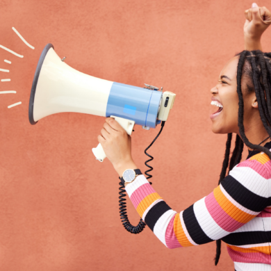 A young person shouting into a megaphone.