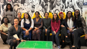 A group of people, stood and sat, as they pose for a photograph at News UK's offices