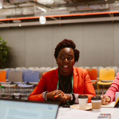 A person sat at a table, talking to others