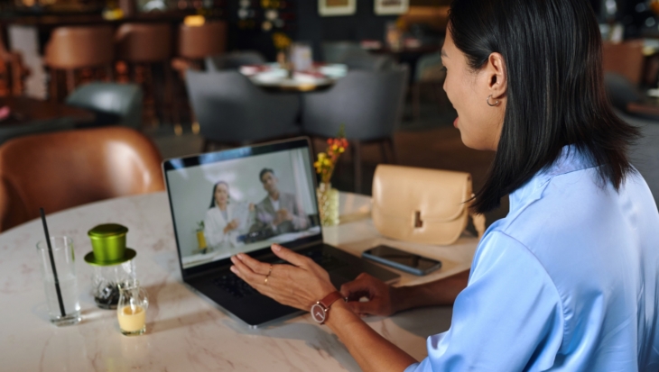 A person on their laptop, taking a video call