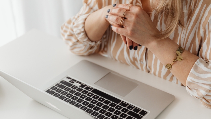 A close-up of a person using their laptop
