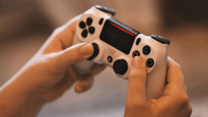 A person holding a PlayStation controller