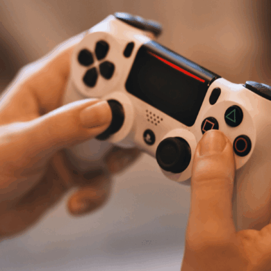 A person holding a PlayStation controller