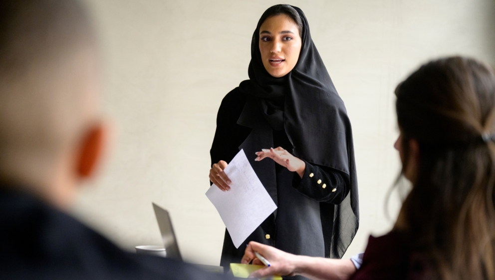 A person stood up, pitching to others