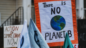 Signs at a climate protest that read 'Action on climate change now' and 'There is no Planet B'