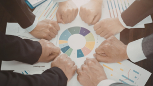 8 people putting their fists down around a colour wheel