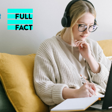 A white woman with tied up blonde hair, black glasses and black headphones sit's on a green sofa with yellow cushions. She is looking at her laptop and notebook.