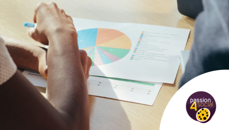 A close-up of a person's arm, holding a pen, as they write on a piece of paper showing a pie chart. Passion4Social logo