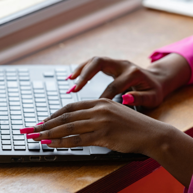 A person typing on a laptop