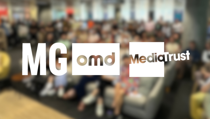MG OMD and Media Trust logos, overlayed on a blurred image of a large group of people at a previous Charity Challenge Day